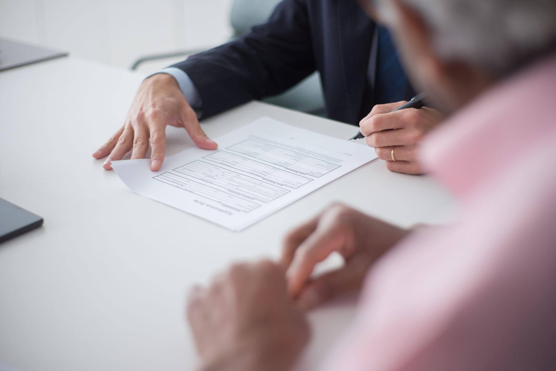 Advisor reviewing an application form with a client at a desk