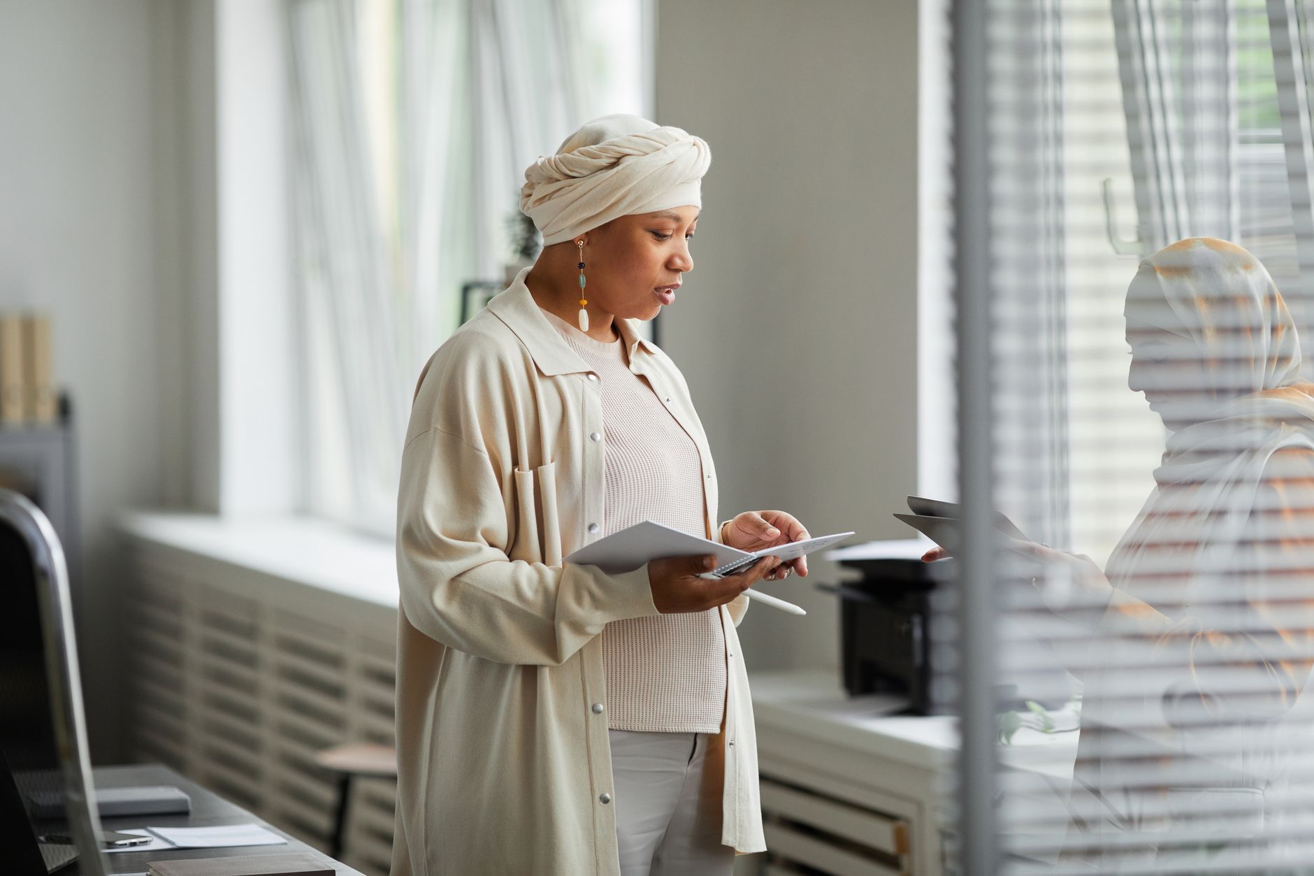 Consultant reading through client documents in a bright white office