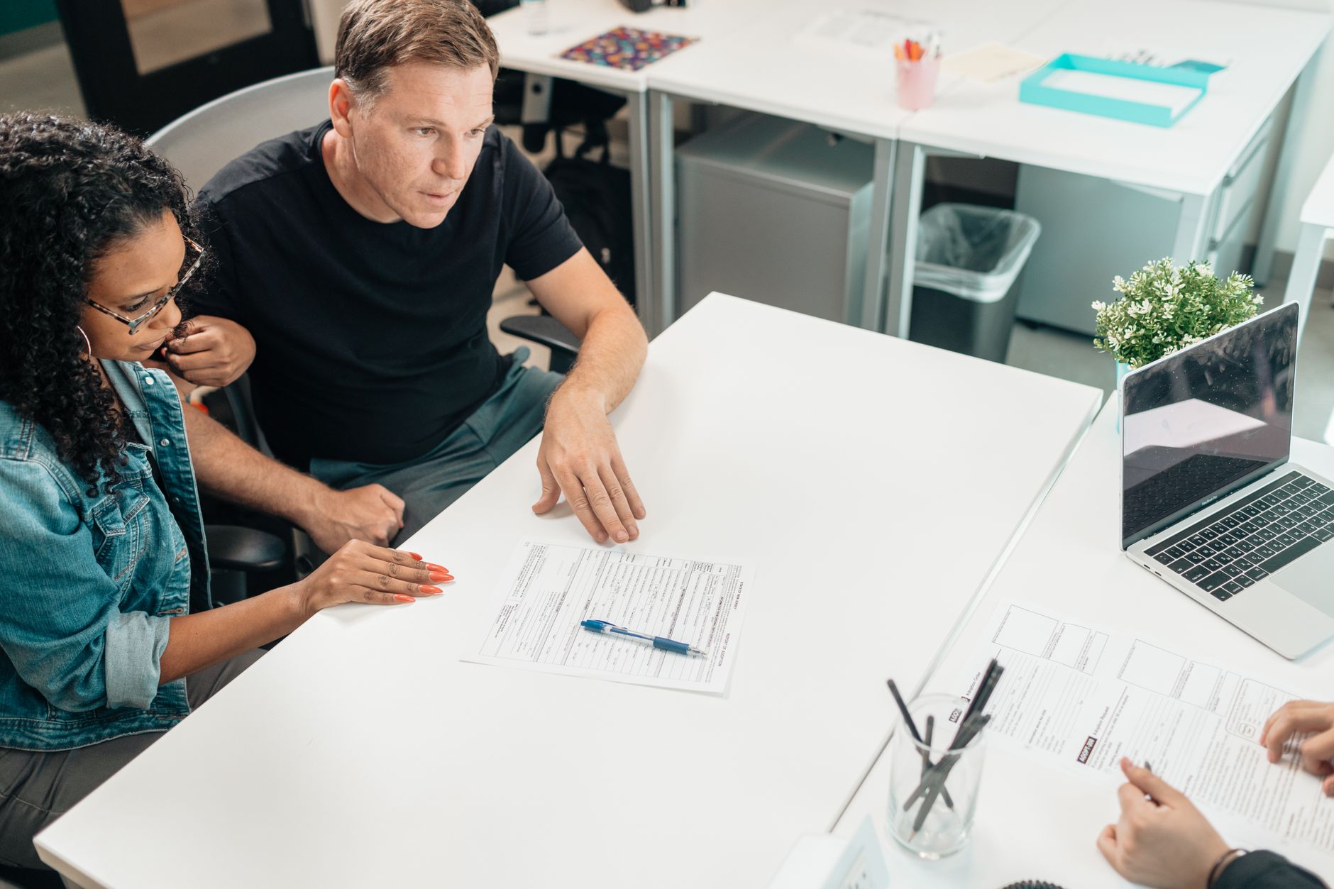 Advisor explaining documents across a desk