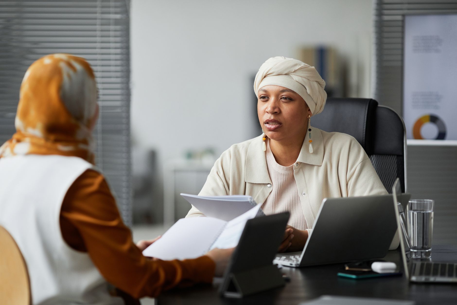 Consultant in a one-to-one meeting with a client in a bright office